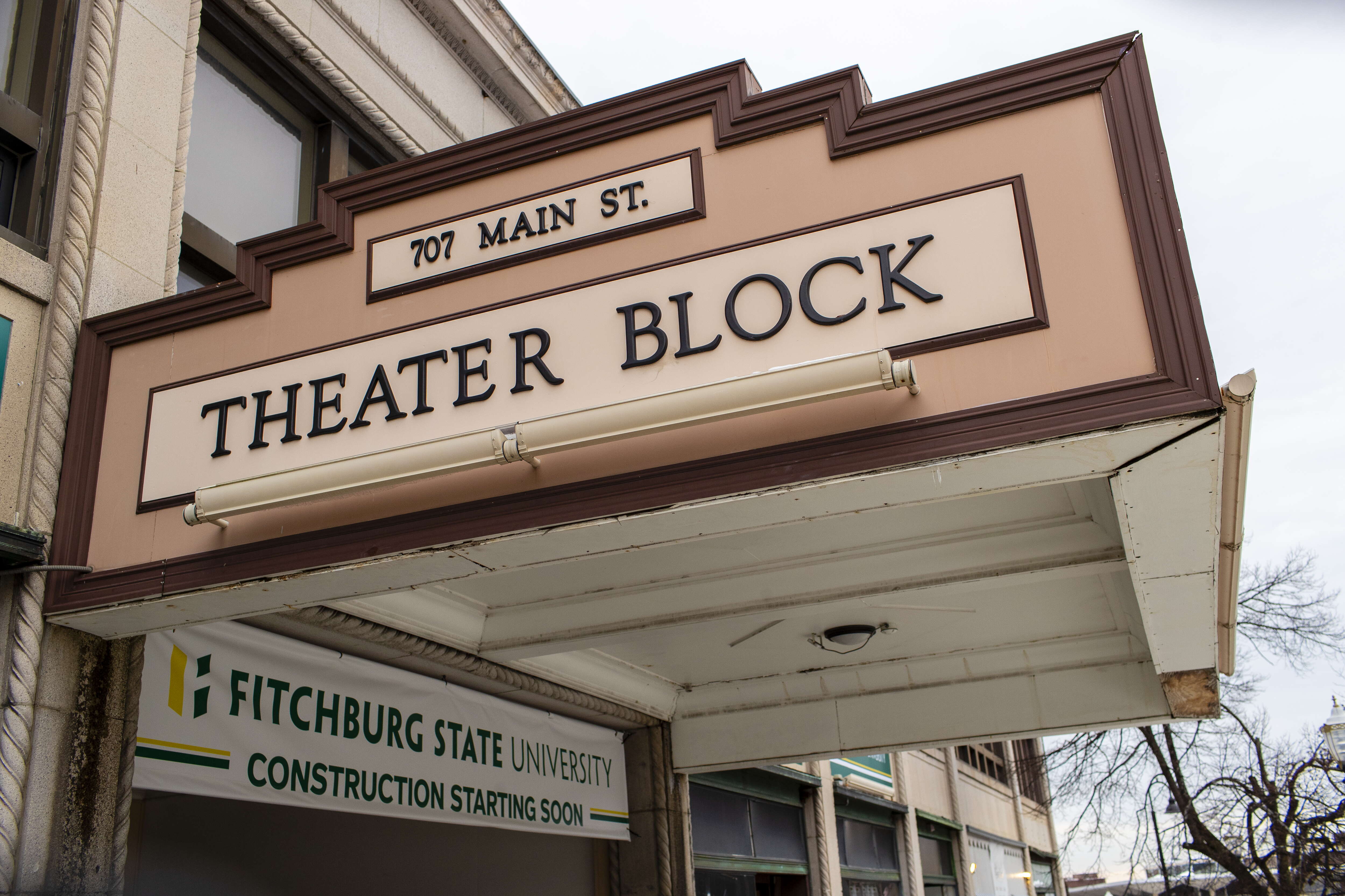 The marquee of an old theater building with a sign that says THEATER BLOCK