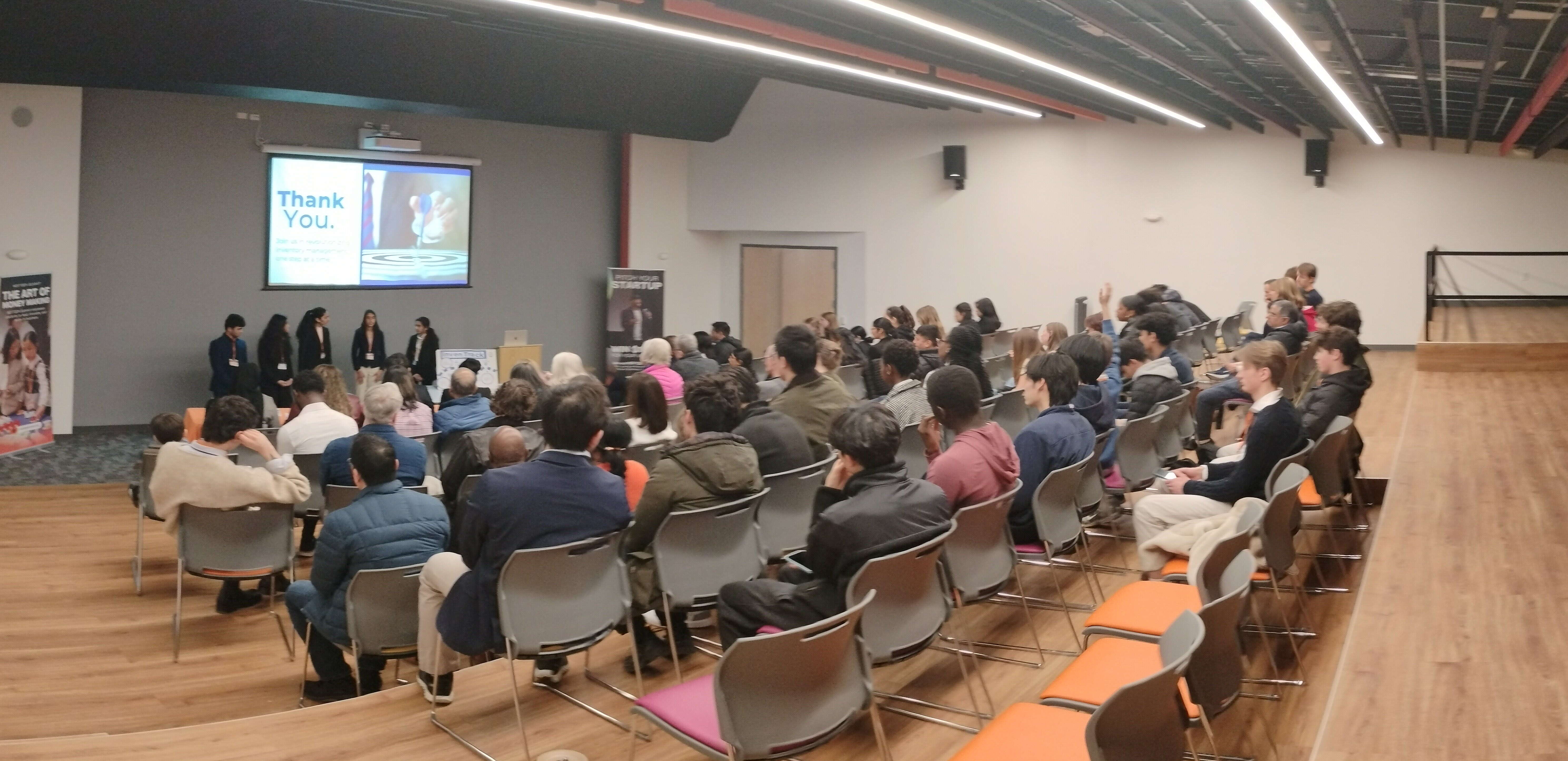 Group of people listening to a presentation in an auditorium