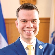 a smiling man in a suit