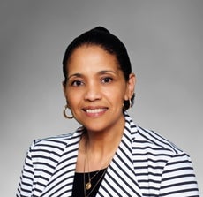 A woman in a white-and-black striped suit