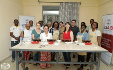 Group of people standing behind a table