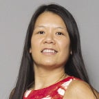 A headshot photo of a woman with black hair in a red dress.