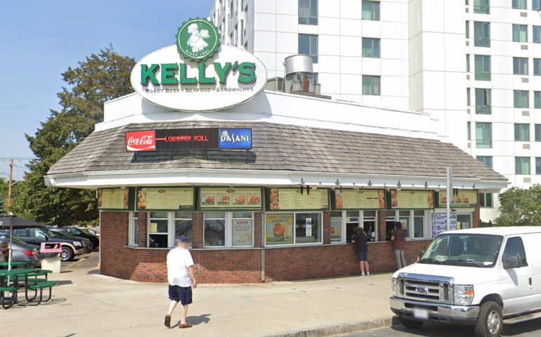 A restaurant storefront with service windows and outdoor seating