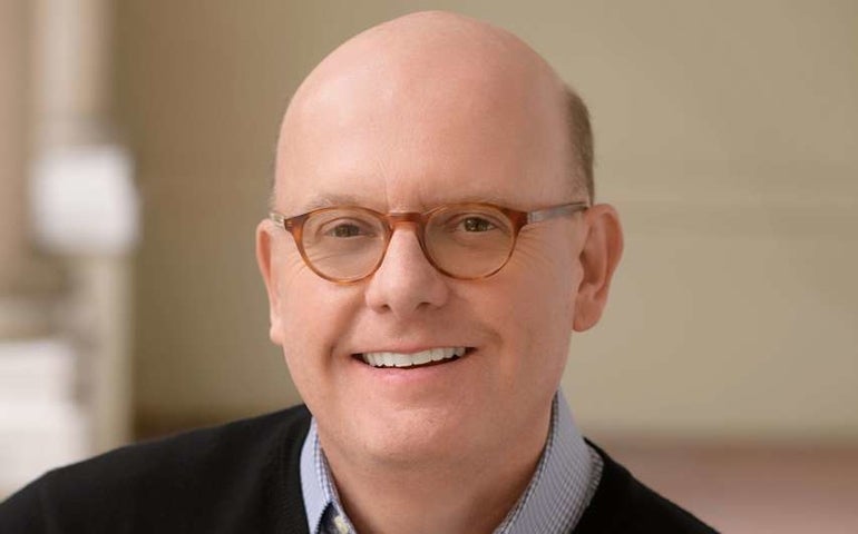 A man with glasses in a portrait photo