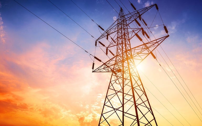 Power lines with sunset in background