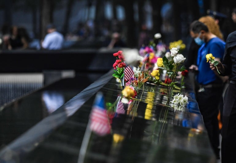 Flowers are placed on the 9/11 Memorial in New York