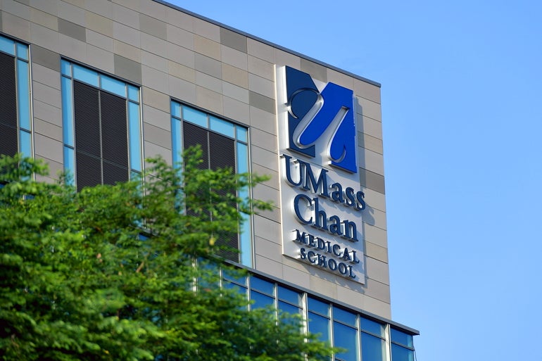 The top corner of a building with a "UMass Chan Medical School" sign on the building