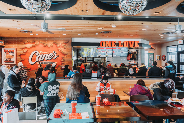 A large group of people inside a fast casual restaurant