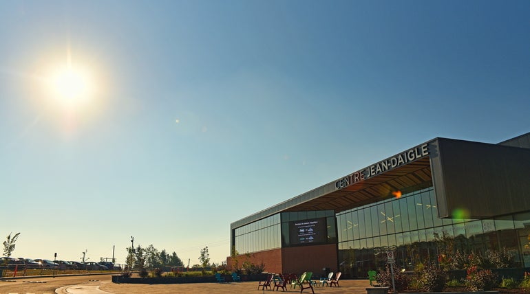 The exterior of a minor league hockey arena, showing a glass facade