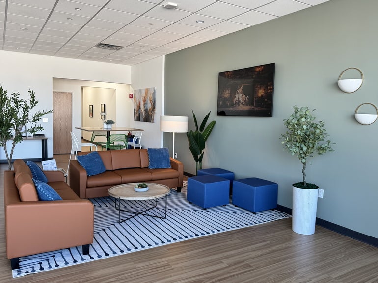 A white-walled room with couches and tables