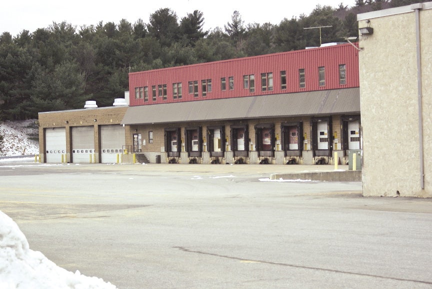 Outside a truck stop plant with 8 truck openings and a large three door garage