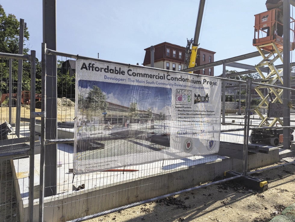 A construction site with a sign on a fence